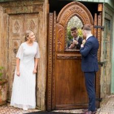 bride and groom in front of a door