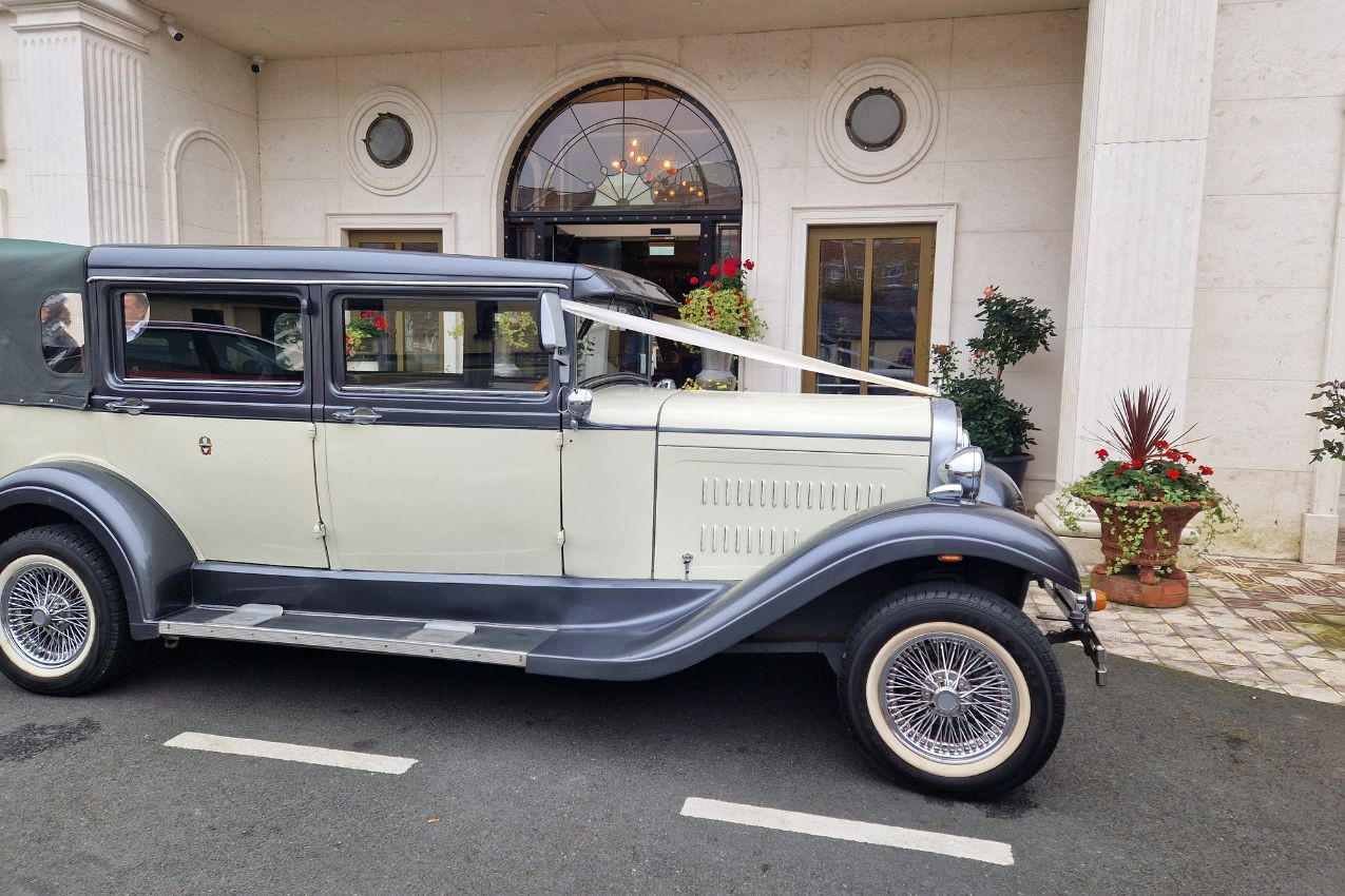 Vintage wedding car outside the hotel entrance
